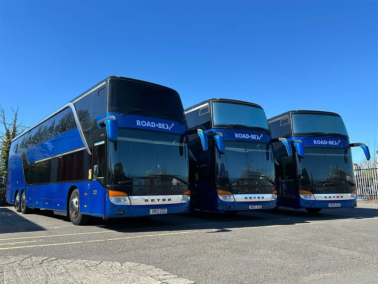 Three ROAD BEDzzz sleeper buses parked in a row